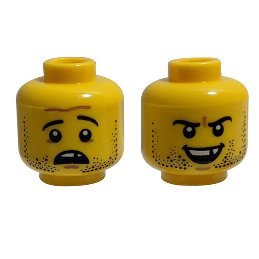 Dual-sided LEGO® minifigure head with stubble, a missing tooth, and a grin/frown expression